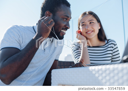 International friends sharing their music tastes 33547859