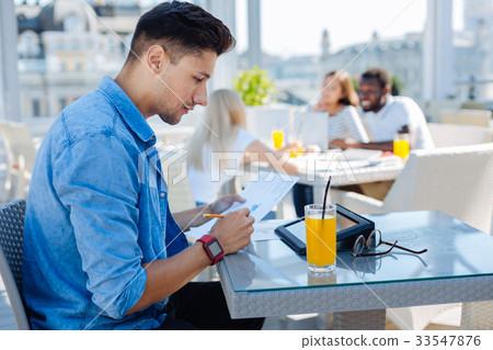 Handsome student studying in cafe Handsome student studying in cafe 33547876
