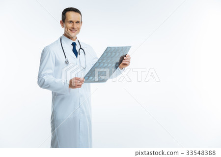 Cheerful medical professional posing with x ray Cheerful medical professional posing with x ray 33548388
