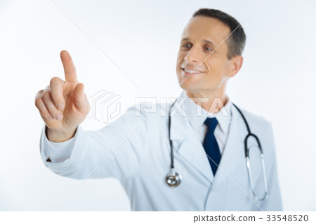 Cheerful medical professional pretending to touch Cheerful medical professional pretending to touch 33548520