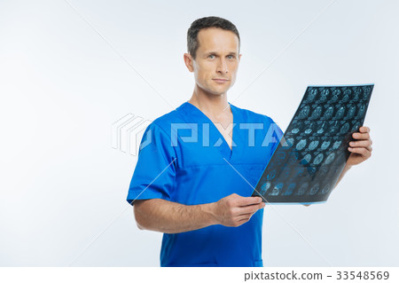Experienced physician examining x ray scan picture Experienced physician examining x ray scan picture 33548569