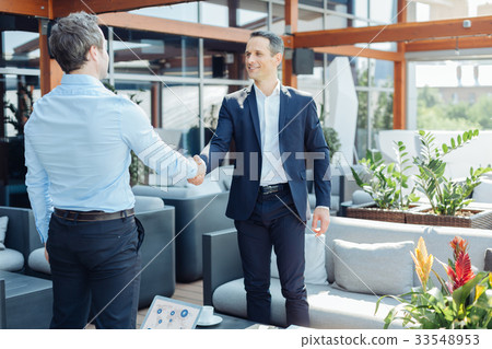 Joyful successful businessmen looking at each Joyful successful businessmen looking at each 33548953