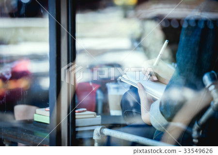 teenage hipster alone at cafe with notebook teenage hipster alone at cafe with notebook 33549626