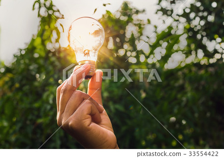 power energy in nature and hand holding light bulb power energy in nature and hand holding light bulb 33554422