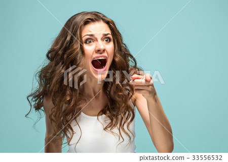 Portrait of young woman with shocked facial Portrait of young woman with shocked facial 33556532