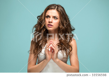 The young woman's portrait with sad emotions 33556598