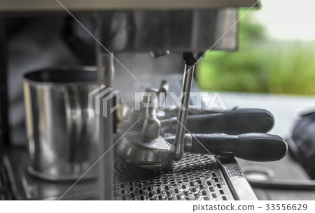 Coffee scoop with steam at Espresso machine 33556629