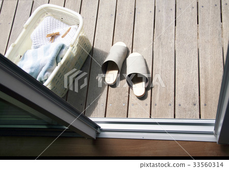 Laundry basket and slippers on the deck 33560314