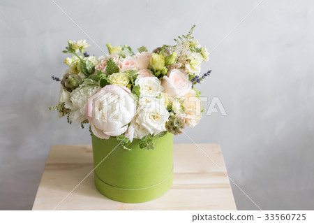Beautiful tender bouquet of flowers in green box 33560725