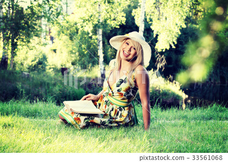 Blonde young woman girl relaxing in a park Blonde young woman girl relaxing in a park 33561068