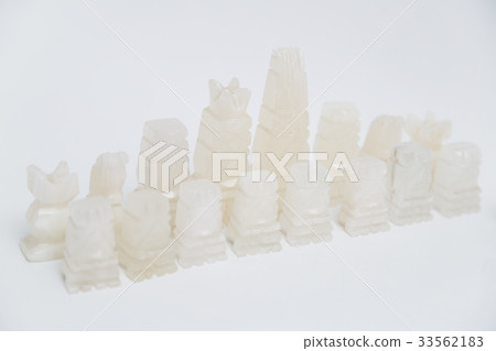 Stone old chess pieces on white background Stone old chess pieces on white background 33562183