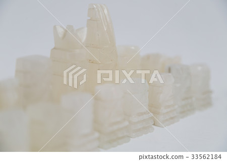 Stone handmade chess pieces on white background Stone handmade chess pieces on white background 33562184