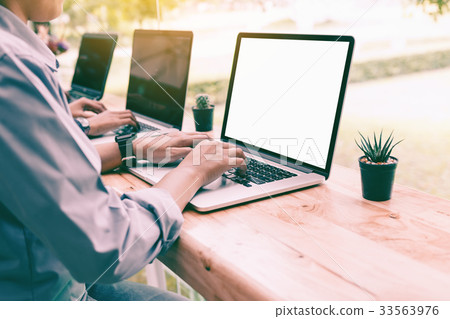 Laptop blank screen with people typing on keyboard 33563976