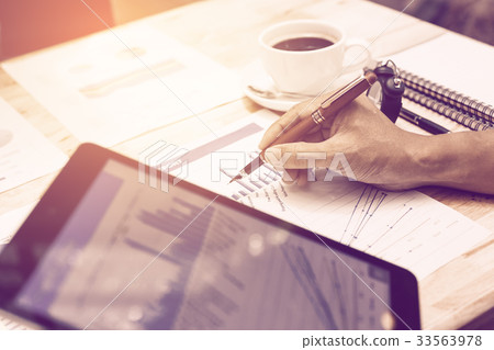 Hand businessman pointing on summary chart report 33563978