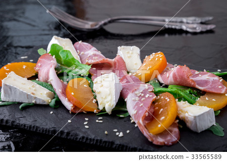 Salad with ham jamon serrano, camembert, arugula 33565589