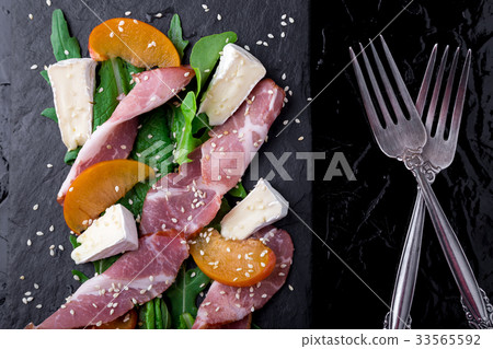 Salad with ham jamon serrano, camembert, melon 33565592