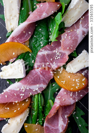 Salad with ham jamon serrano, camembert, melon 33565595