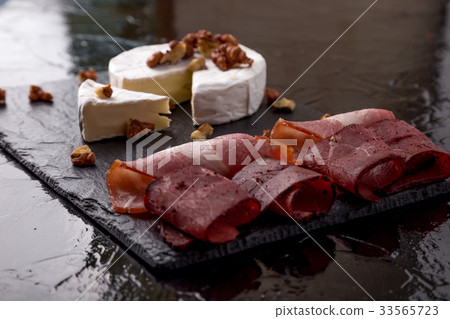 Cheese camembert with walnuts and meat plate with Cheese camembert with walnuts and meat plate with 33565723