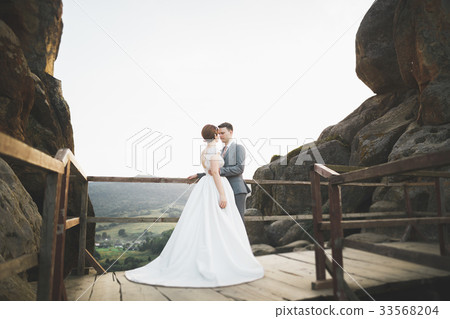 Kissing wedding couple staying over beautiful Kissing wedding couple staying over beautiful 33568204