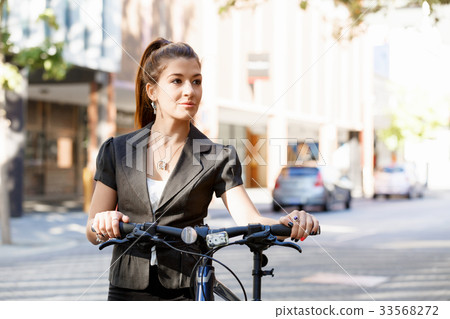 Young woman commuting on bicycle Young woman commuting on bicycle 33568272