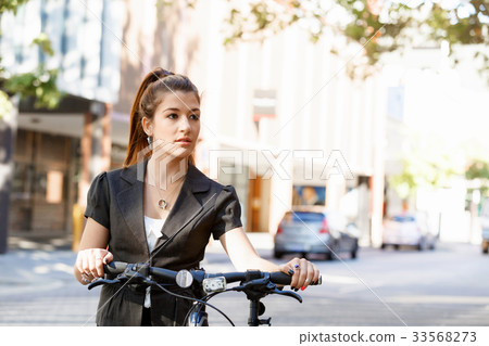 Young woman commuting on bicycle Young woman commuting on bicycle 33568273