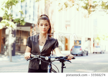 Young woman commuting on bicycle Young woman commuting on bicycle 33568274