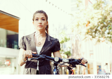 Young woman commuting on bicycle Young woman commuting on bicycle 33568276