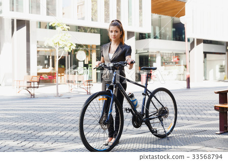 Young woman commuting on bicycle Young woman commuting on bicycle 33568794
