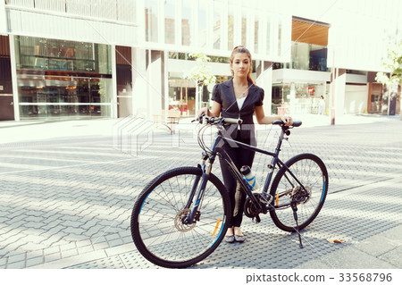 Young woman commuting on bicycle Young woman commuting on bicycle 33568796