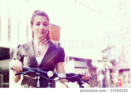 Young woman commuting on bicycle Young woman commuting on bicycle 33569293