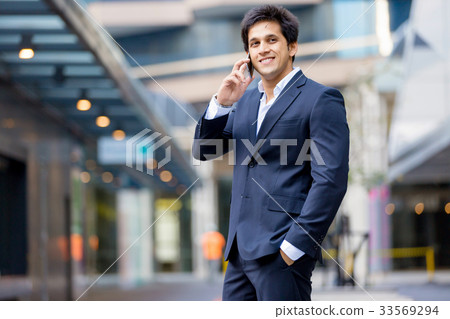 Portrait of confident businessman with mobile phone outdoors Portrait of confident businessman with mobile phone outdoors 33569294