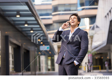 Portrait of confident businessman with mobile phone outdoors Portrait of confident businessman with mobile phone outdoors 33569393