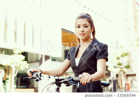 Young woman commuting on bicycle Young woman commuting on bicycle 33569394