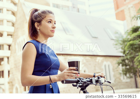 Young woman commuting on bicycle 33569615