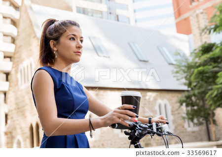 Young woman commuting on bicycle Young woman commuting on bicycle 33569617