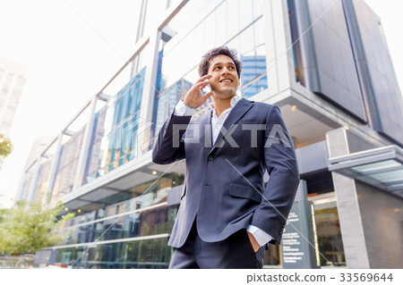 Portrait of confident businessman with mobile phone outdoors Portrait of confident businessman with mobile phone outdoors 33569644