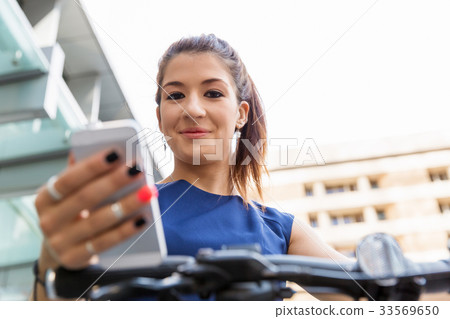Business woman with a smart phone Business woman with a smart phone 33569650