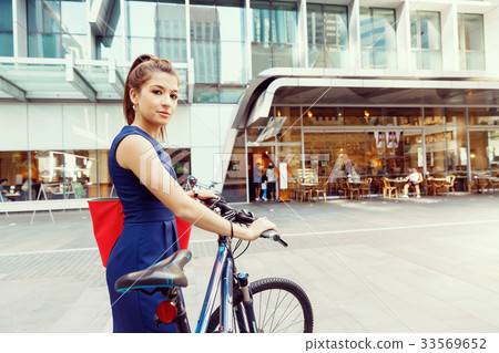 Young woman commuting on bicycle Young woman commuting on bicycle 33569652