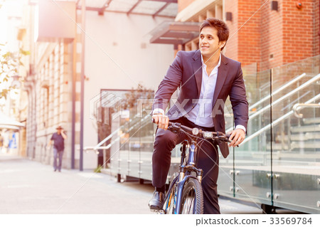 Successful businessman with bicycle Successful businessman with bicycle 33569784