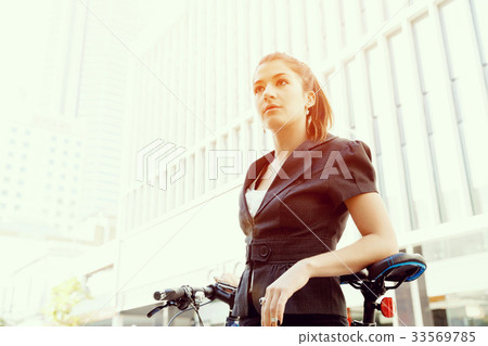 Young woman commuting on bicycle Young woman commuting on bicycle 33569785