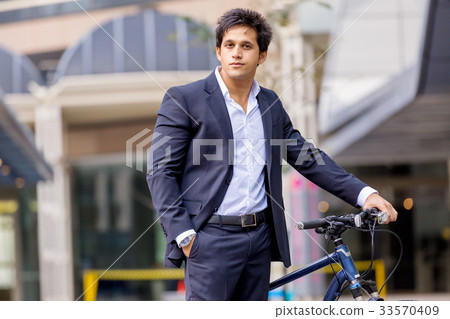 Successful businessman riding bicycle 33570409