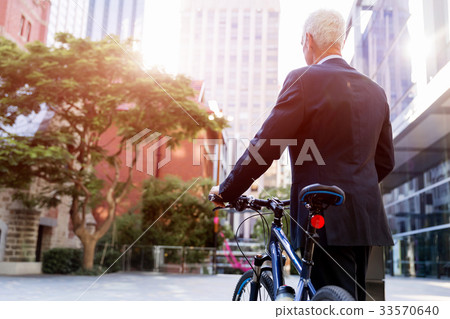 Successful businessman riding bicycle 33570640