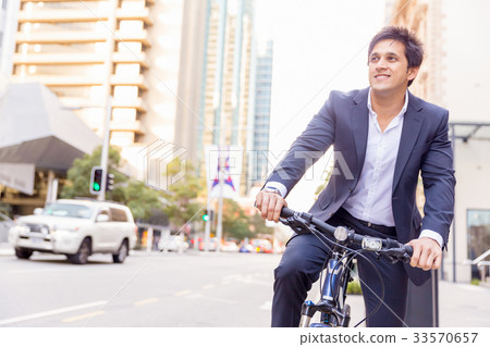 Successful businessman riding bicycle 33570657
