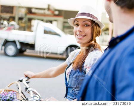 Beautiful woman riding on bike 33573086