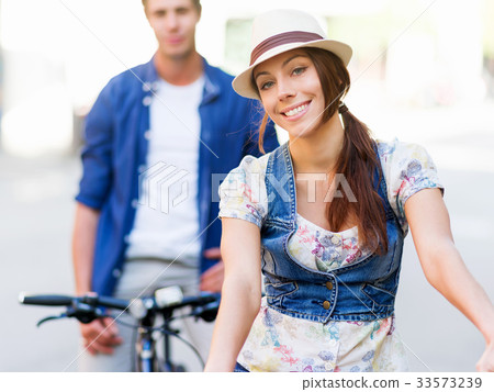 Beautiful woman riding on bike Beautiful woman riding on bike 33573239
