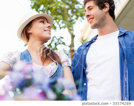 Happy couple in city with bike 33574289