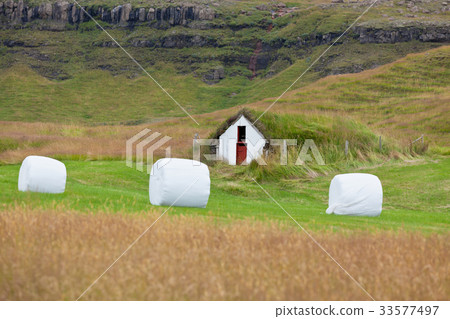 White Hay Rolls on a Green Field of Iceland White Hay Rolls on a Green Field of Iceland 33577497