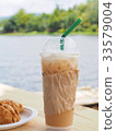 ice coffee with curry on wooden table. 33579004