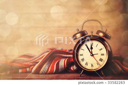 Alarm clock and scarf. Alarm clock and scarf. 33582263