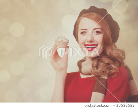 Redhead girl with cupcake 33582582